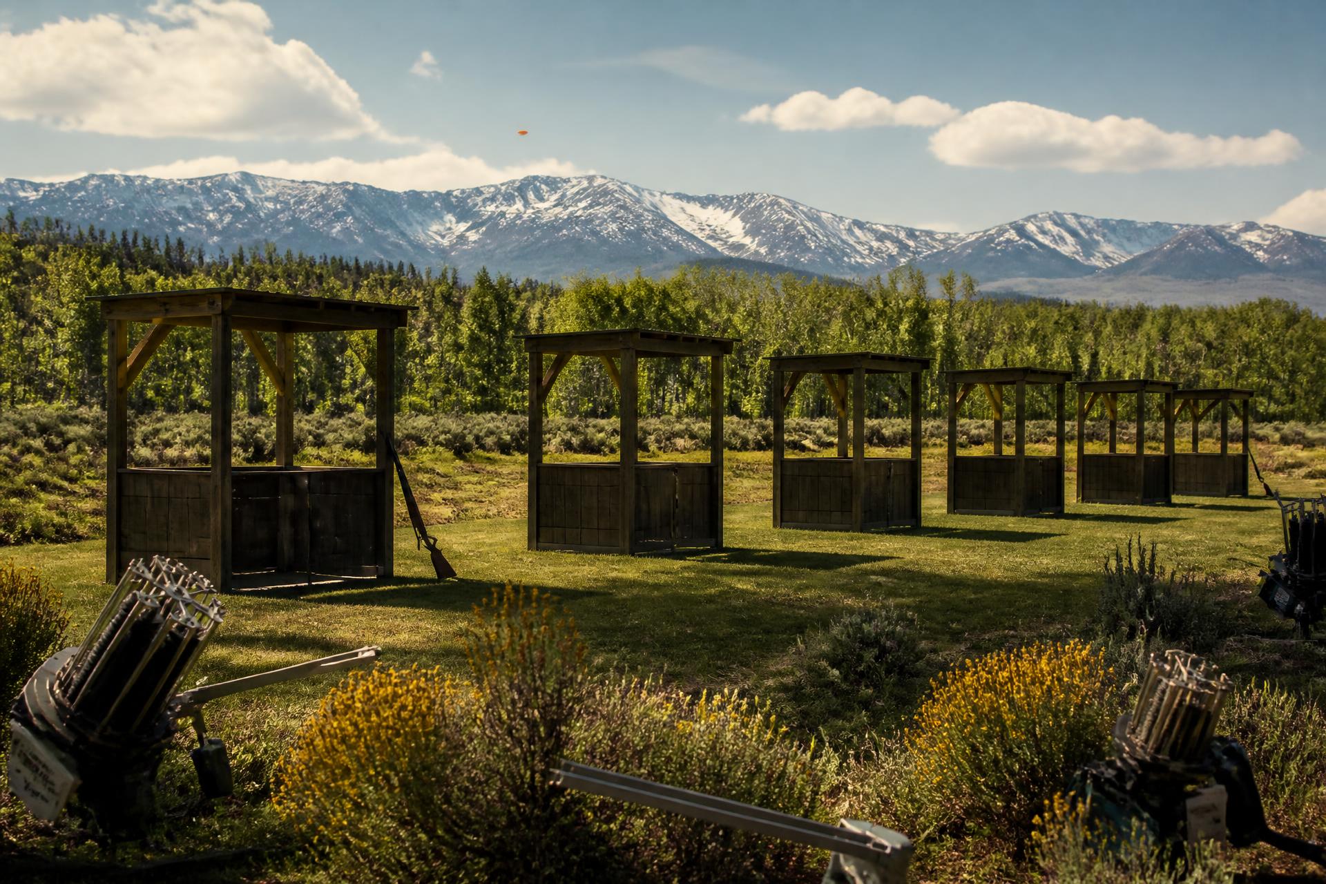 The five-stand sporting clays pavilion in a meadow beneath the Wasatch Range